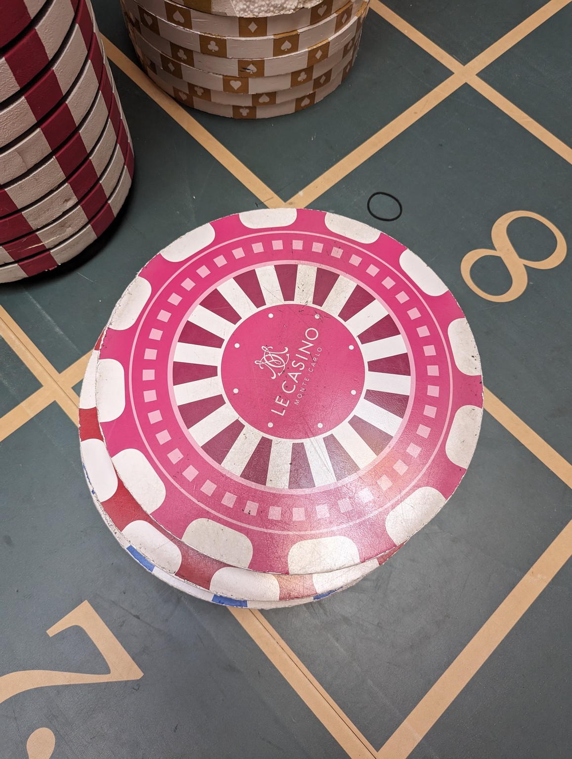 a stack of poker chips on a tile floor