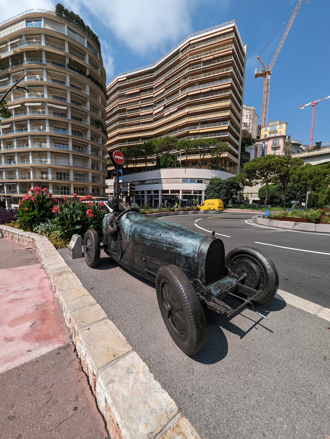 a statue of a car on a street