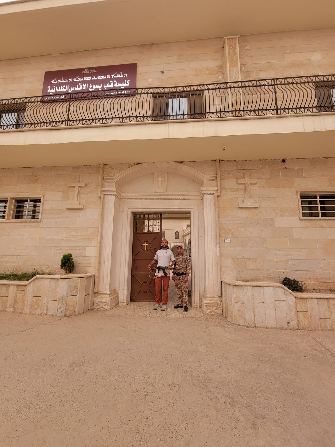 two men standing in front of a building