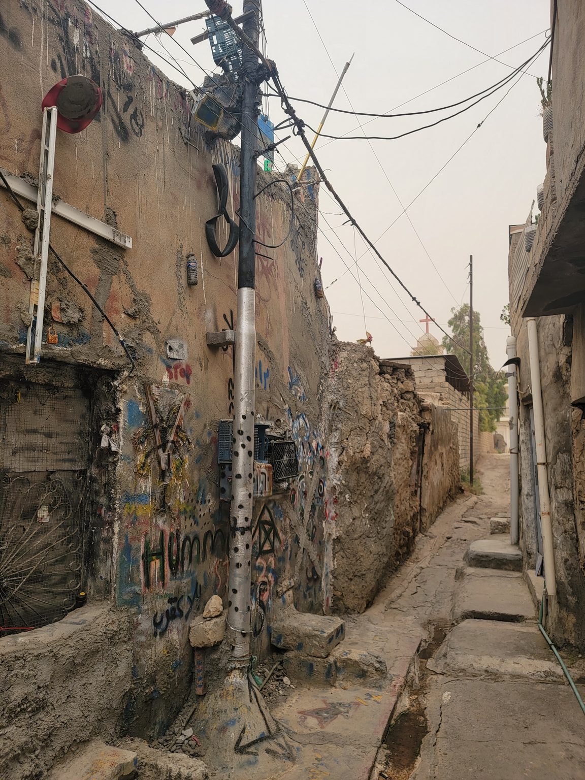 a street with graffiti on the side of a building