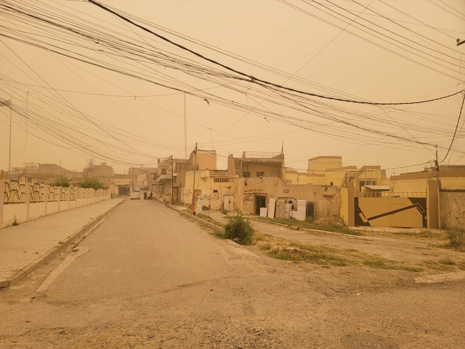 a street with buildings and power lines