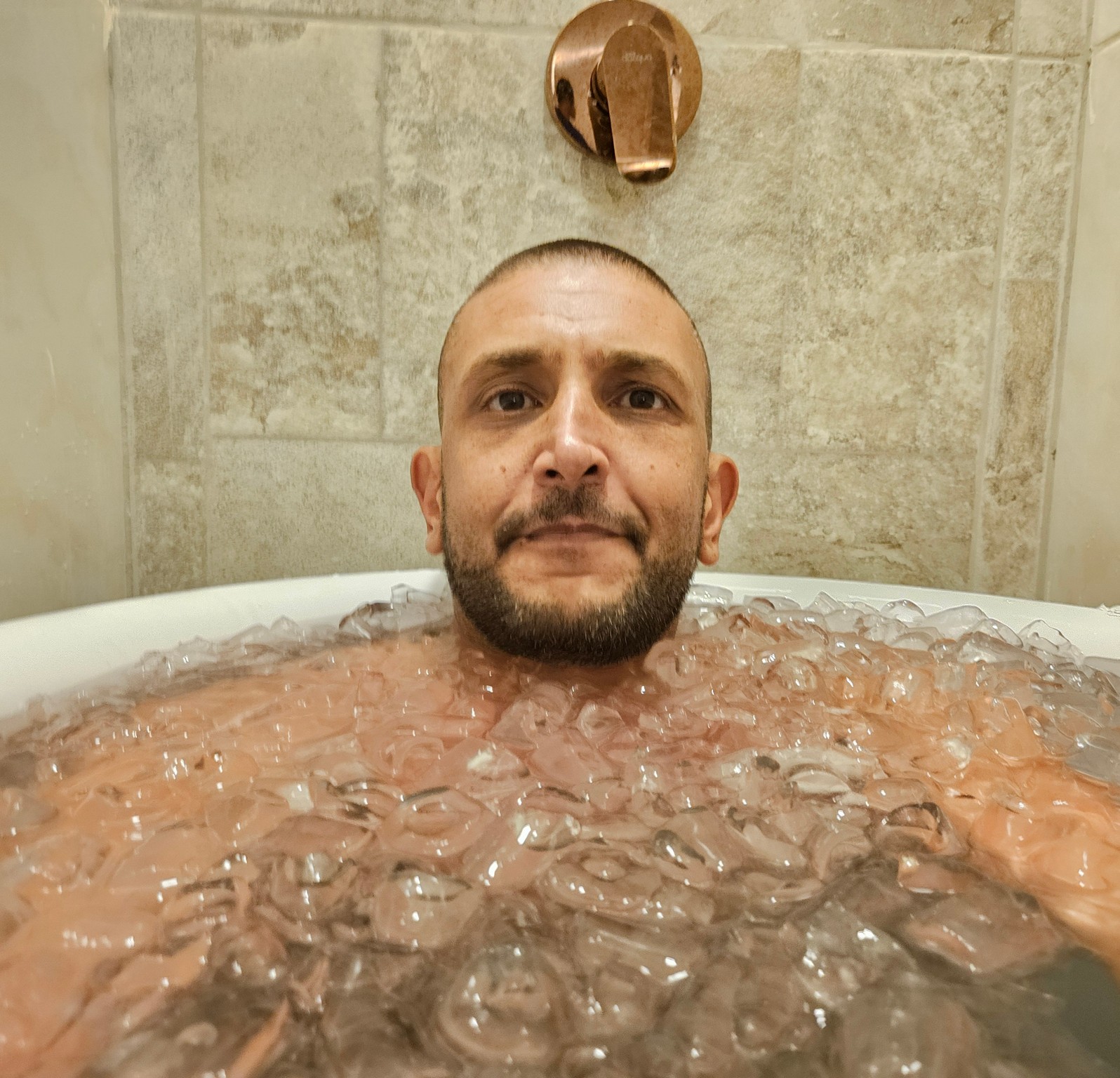 a man in a tub of ice