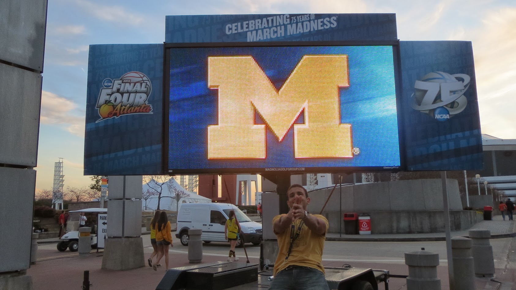 a man standing in front of a large screen