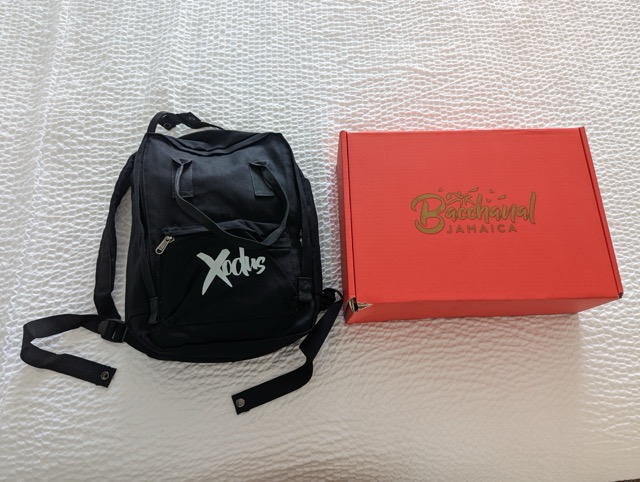 a black backpack next to a red box