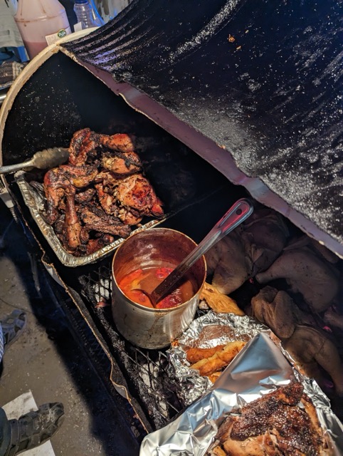 a barrel of food with a metal container and metal utensils