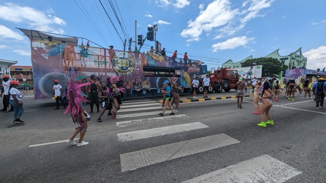 a group of people in clothing crossing a street
