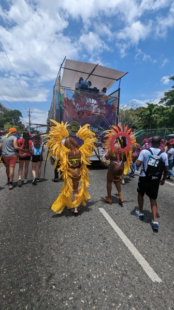 a group of people in clothing walking down a street
