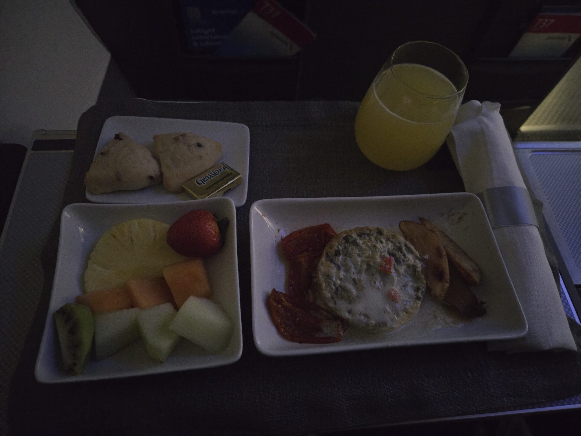 a plate of food and a glass of juice