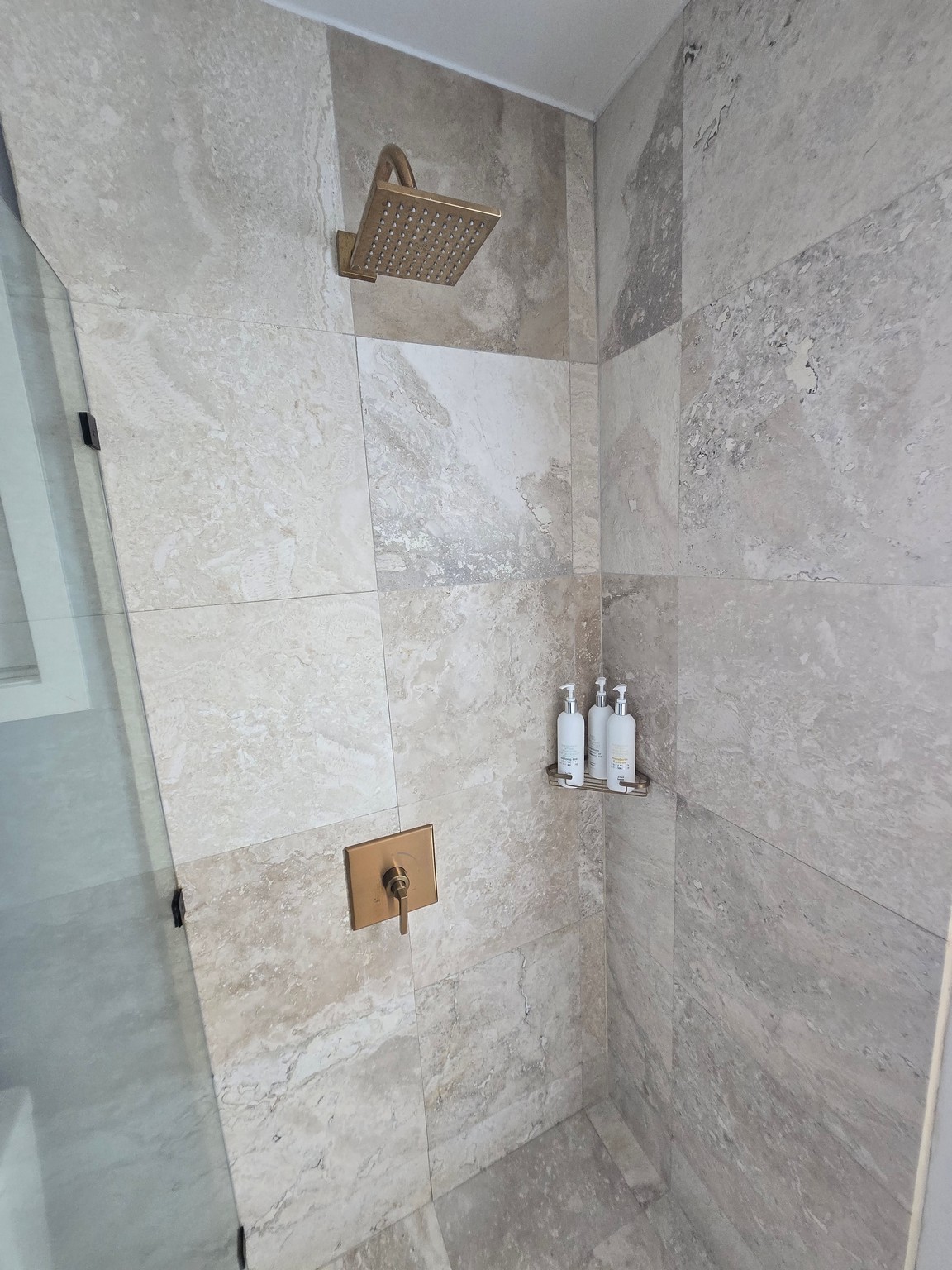a shower with a shower head and a shower head