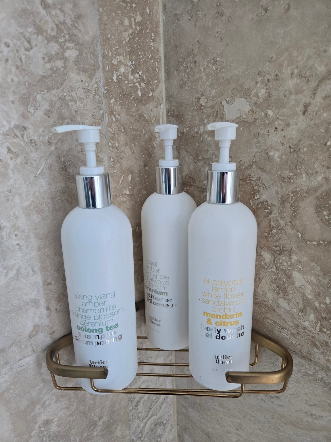 a group of white bottles on a metal shelf