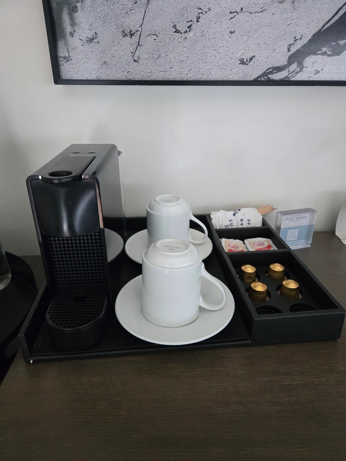 a coffee machine and cups on a tray