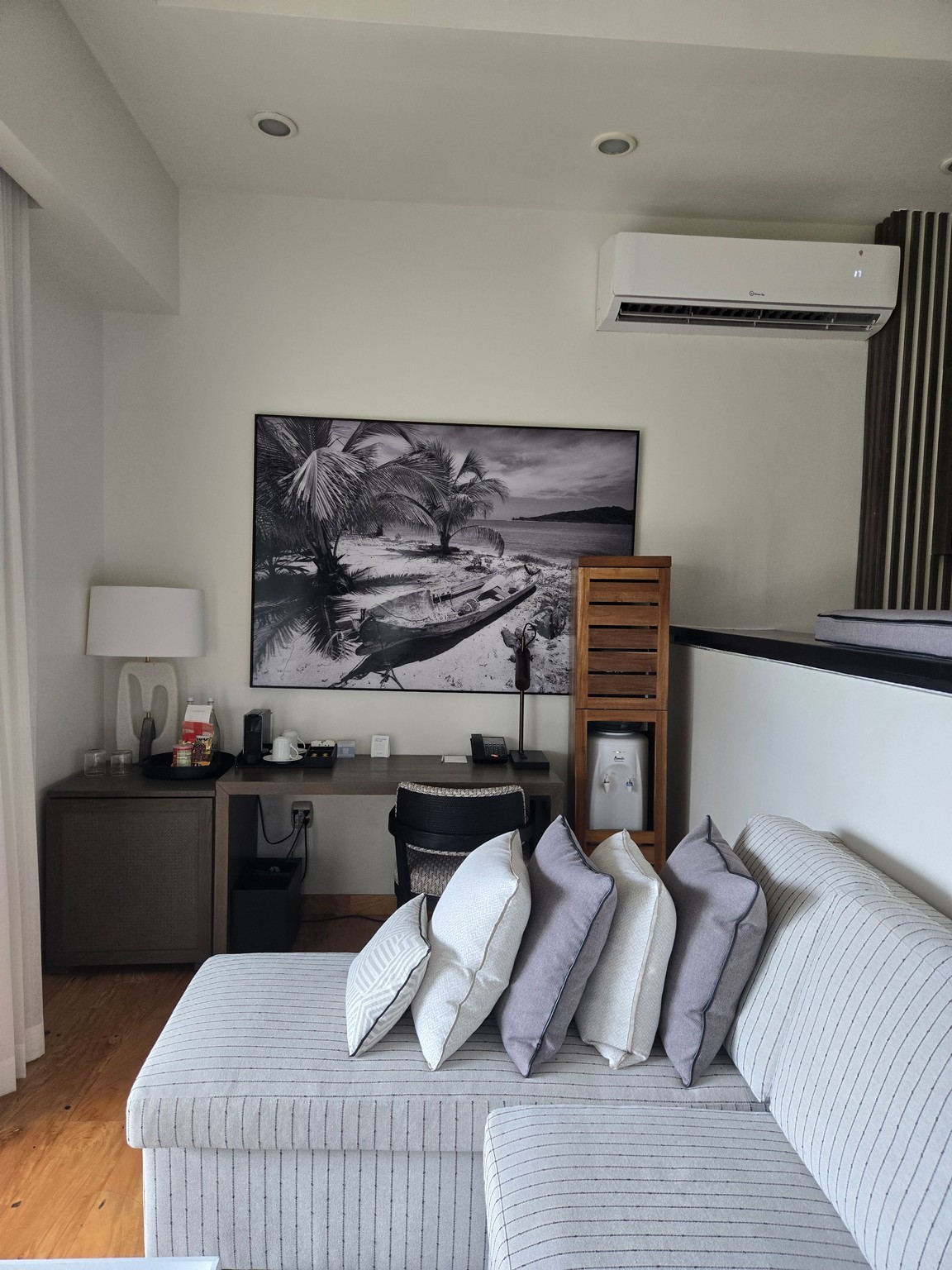 a room with a couch and a painting
