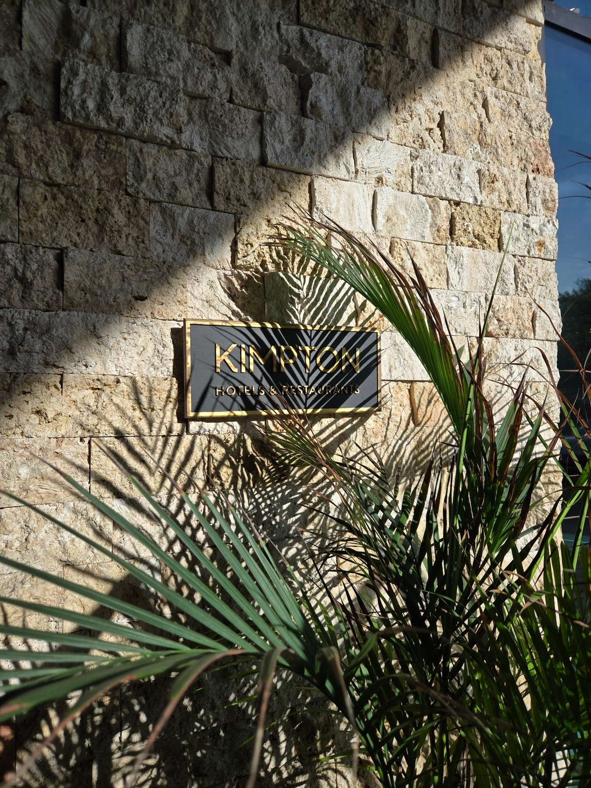 a sign on a stone wall