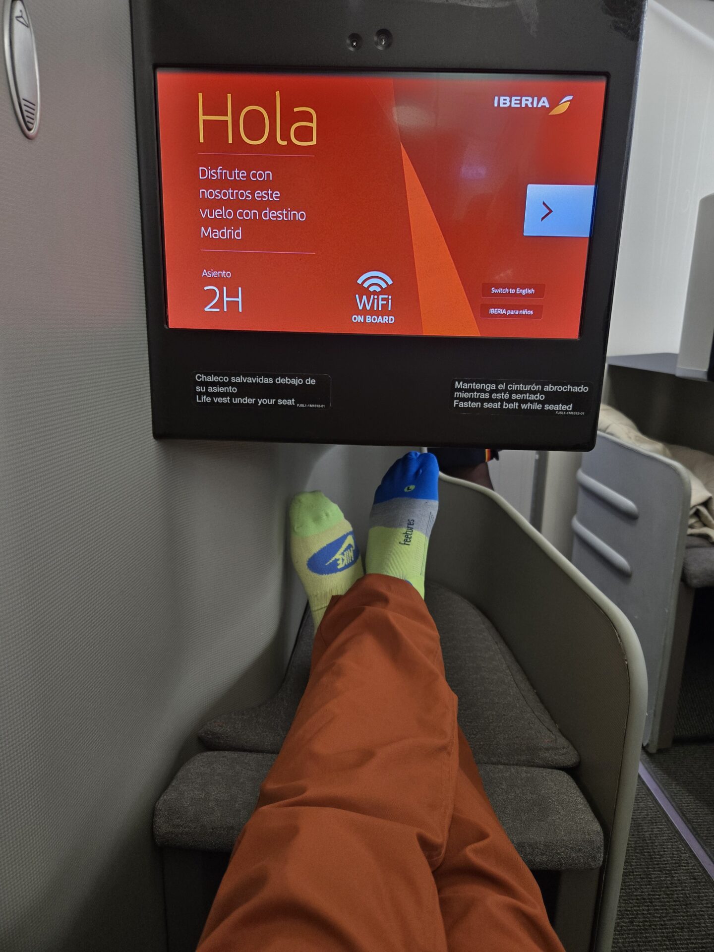 a person's feet in a chair with a tv