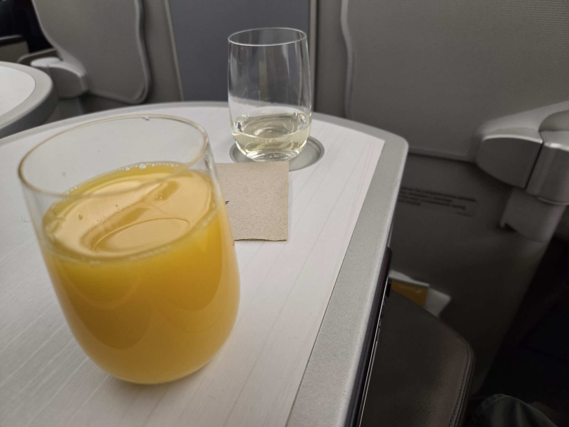 a glass of orange juice and a glass of water on a table