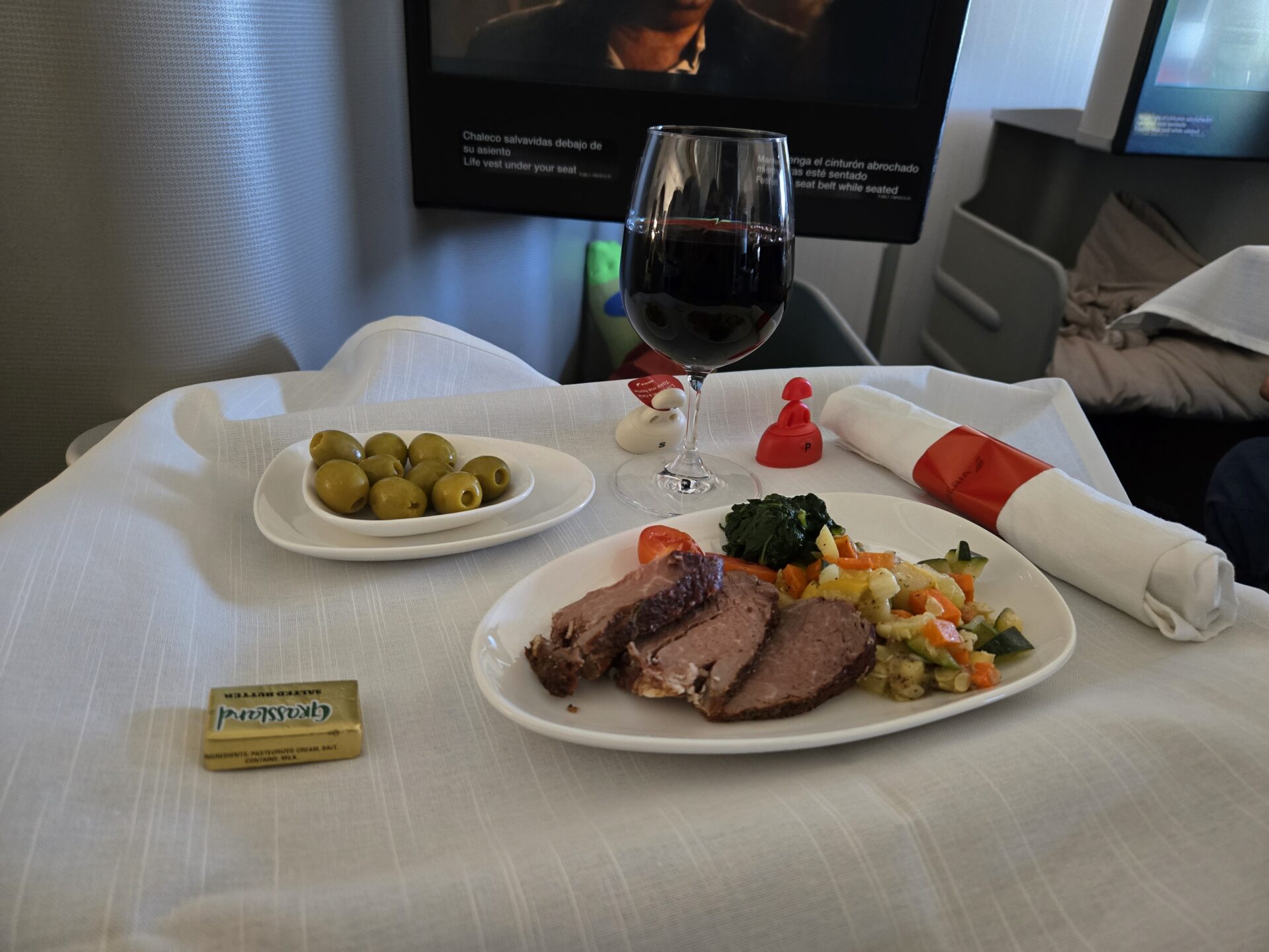 a plate of food and a glass of wine on a table