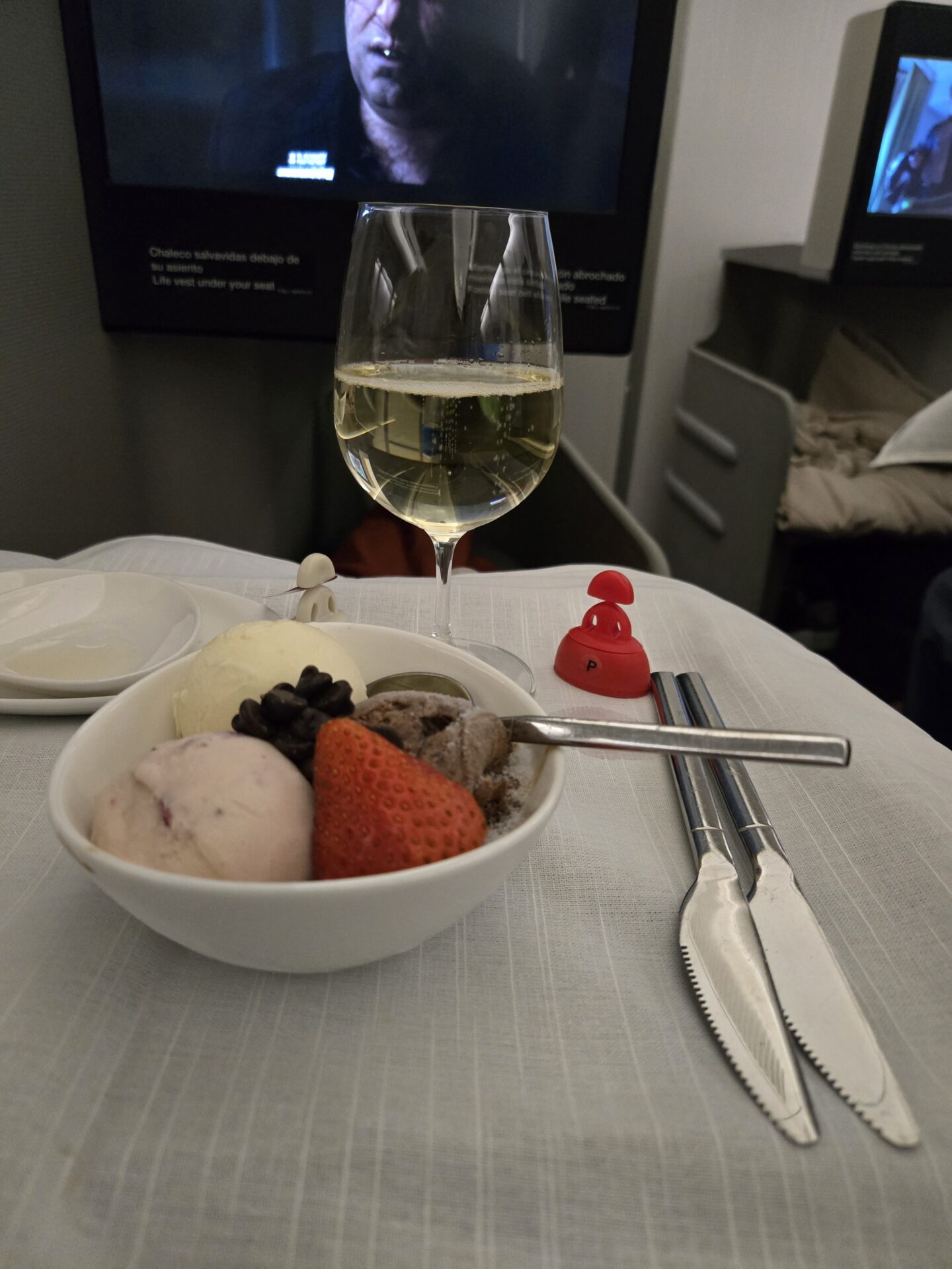 a bowl of ice cream and a glass of wine
