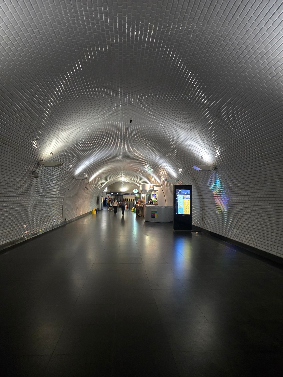 a tunnel with people walking in it