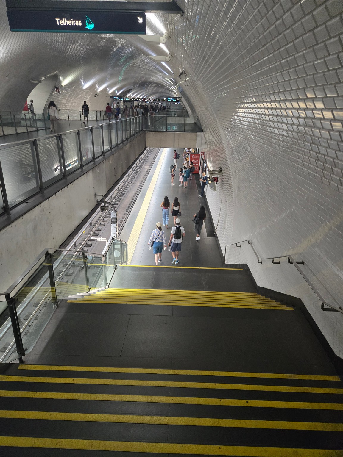 people walking down a tunnel