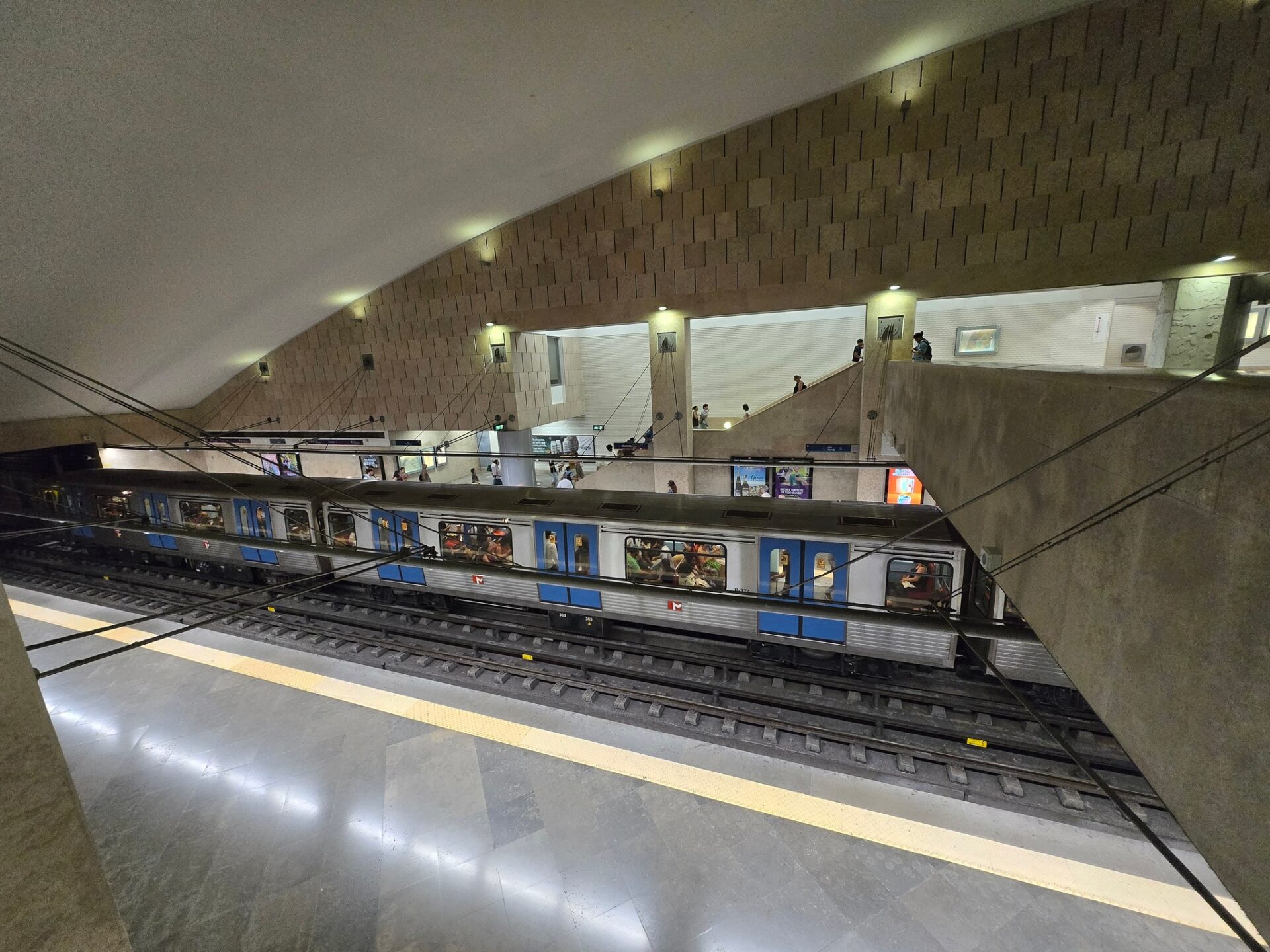 a train station with people on the tracks