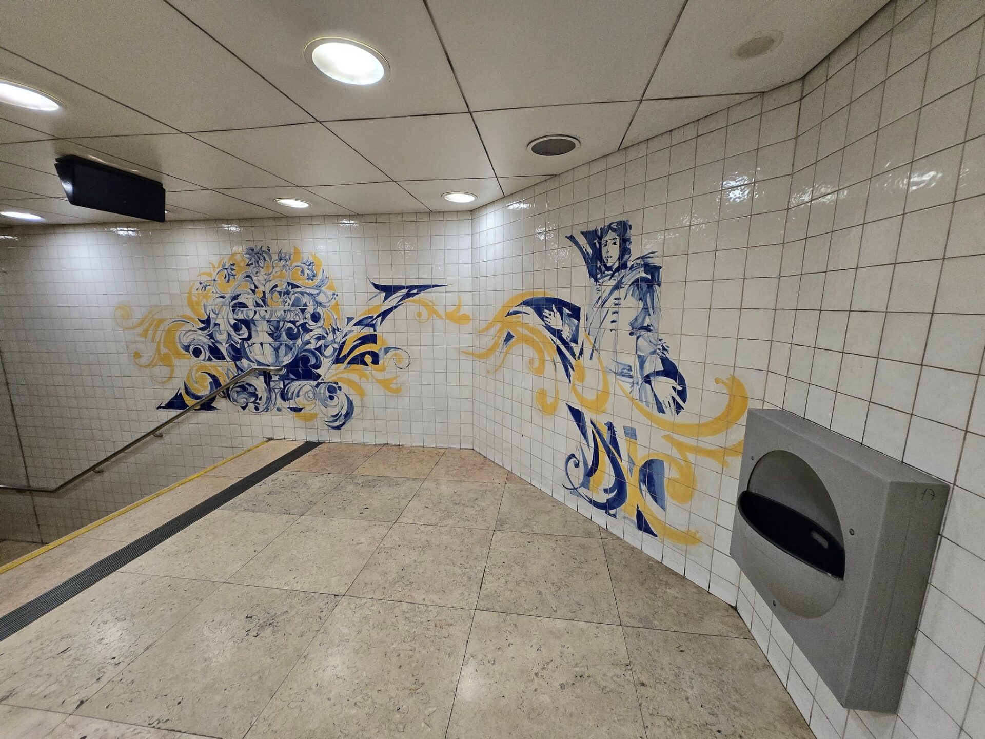 a tiled wall with a mural on the wall