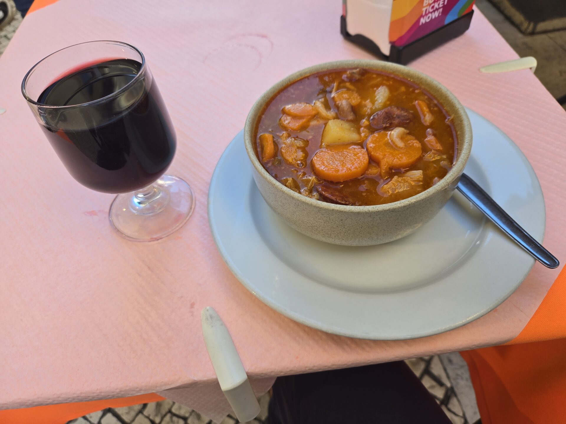 a bowl of soup and a glass of wine