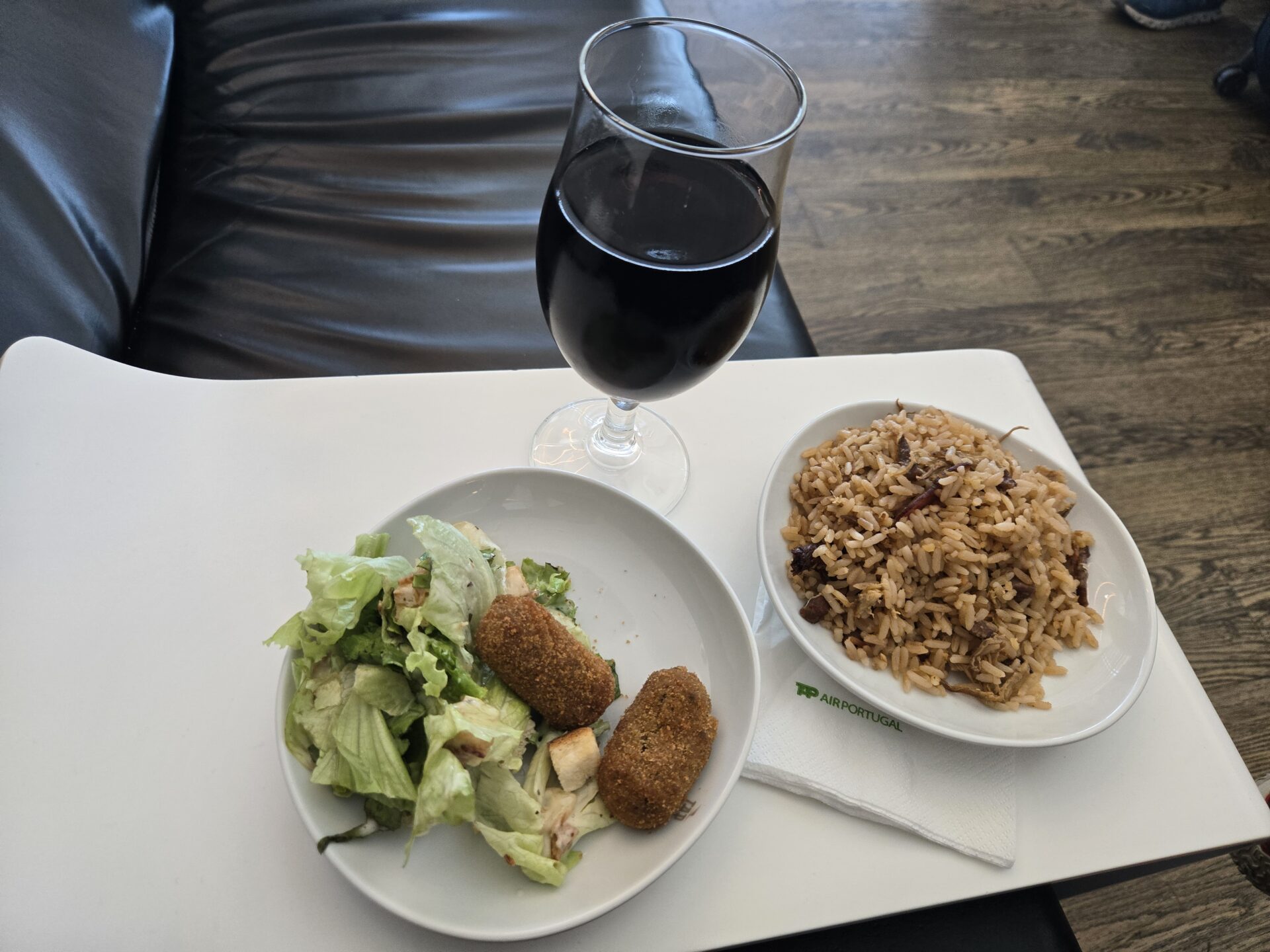 a plate of food and a glass of wine