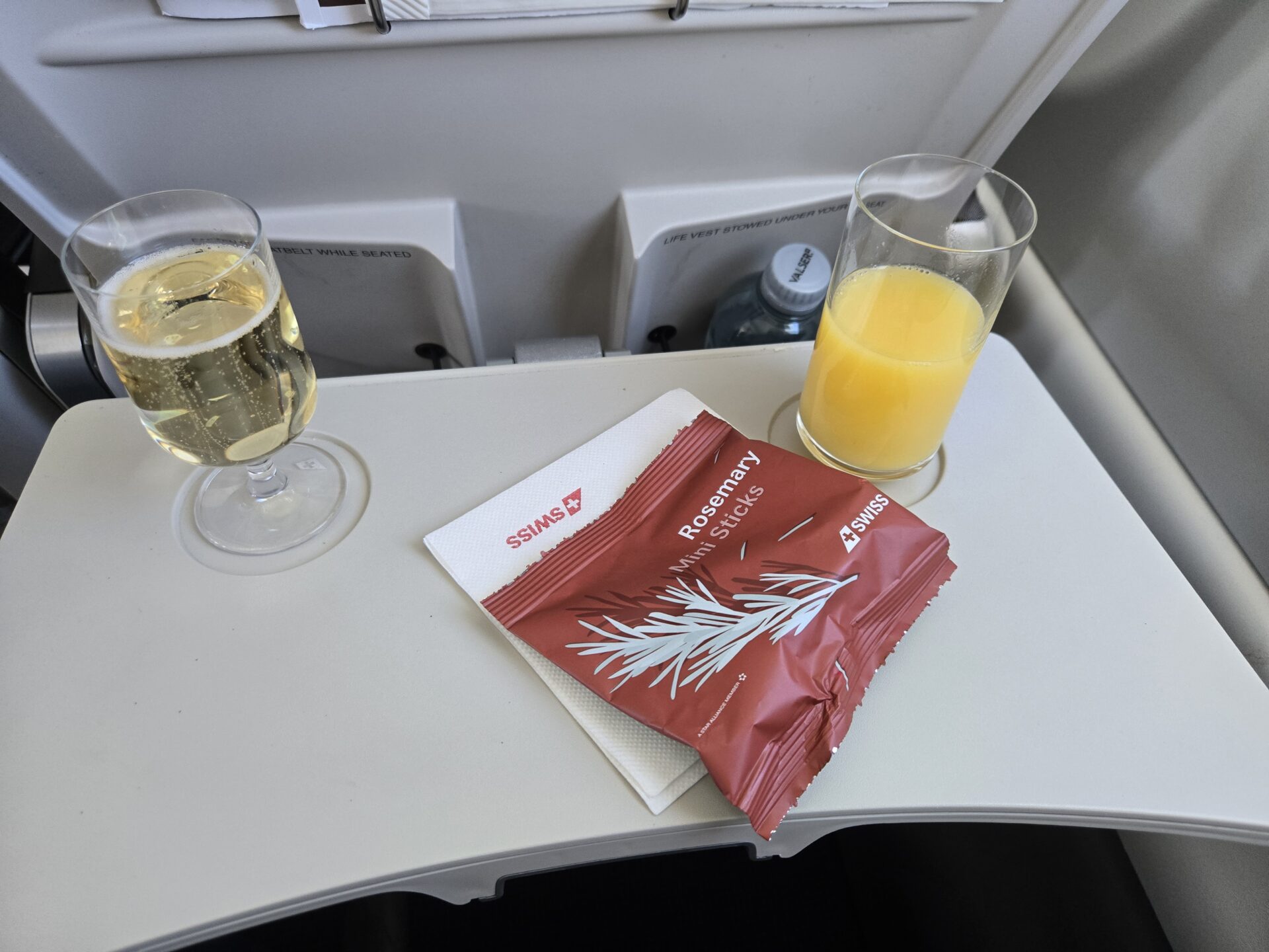 a glass of juice and a bag of orange juice on a table