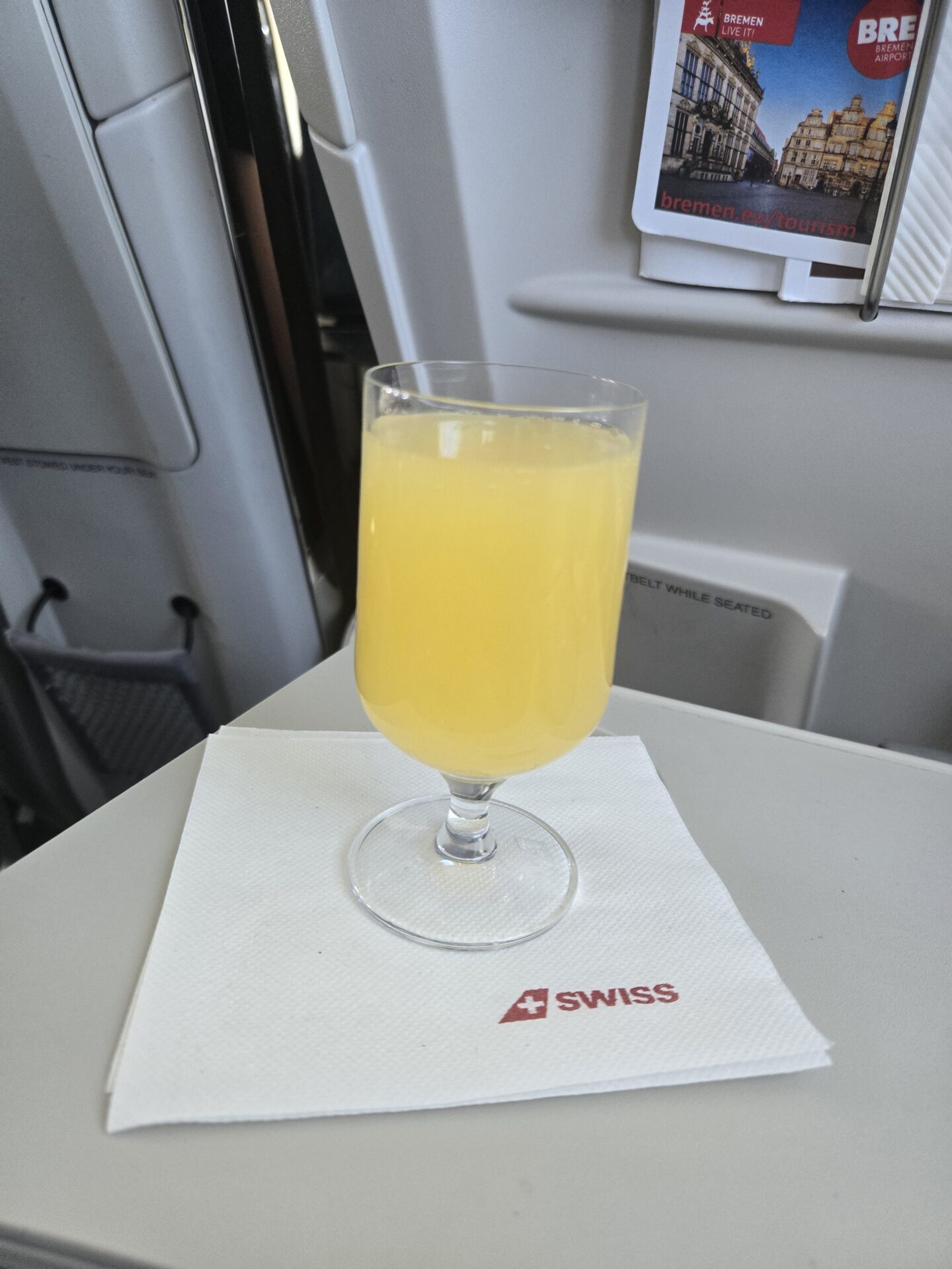 a glass of orange juice on a table