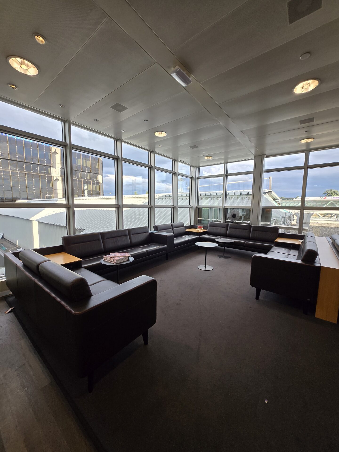 a room with couches and tables in front of windows