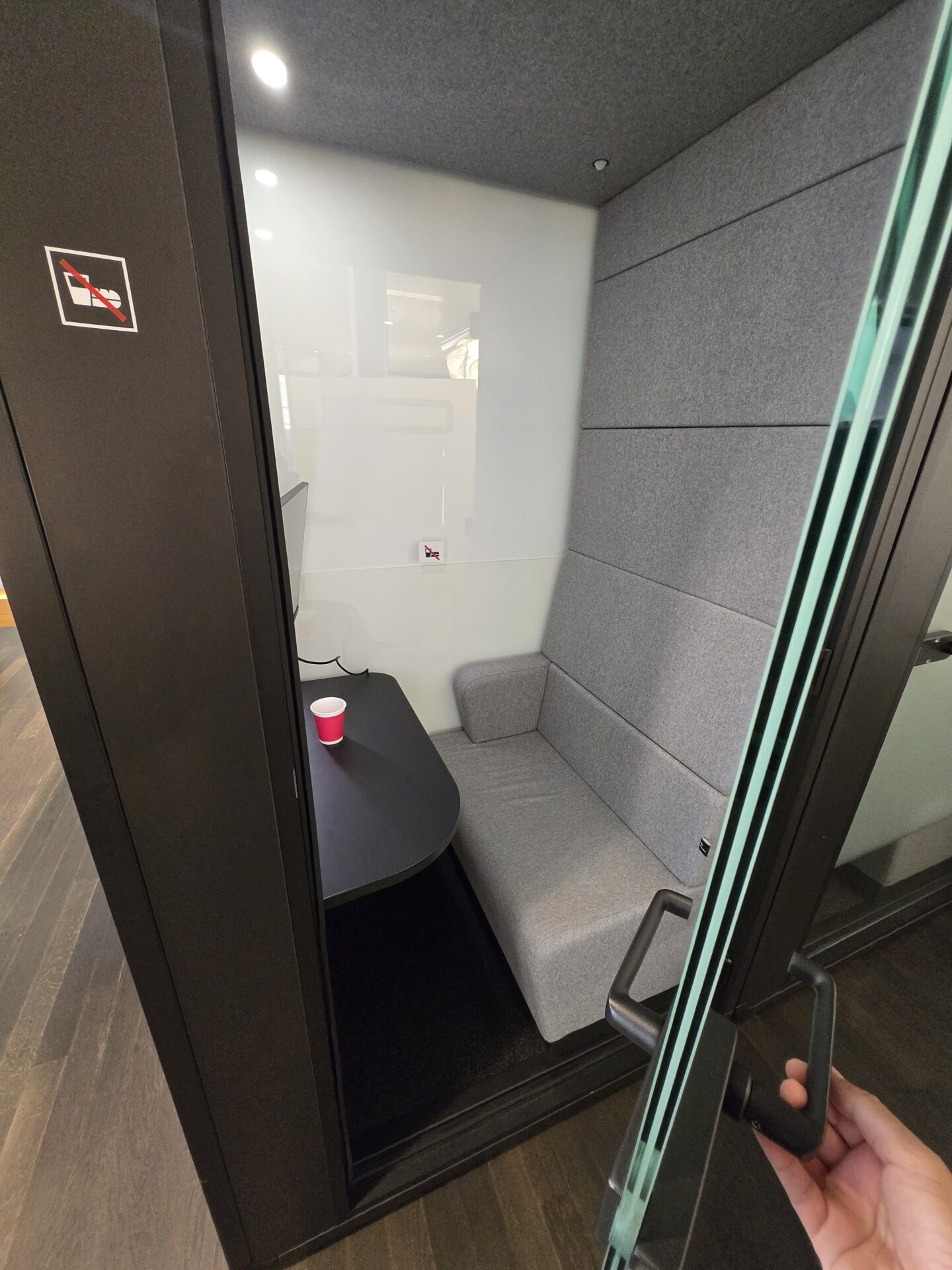 a phone booth with a table and a cup