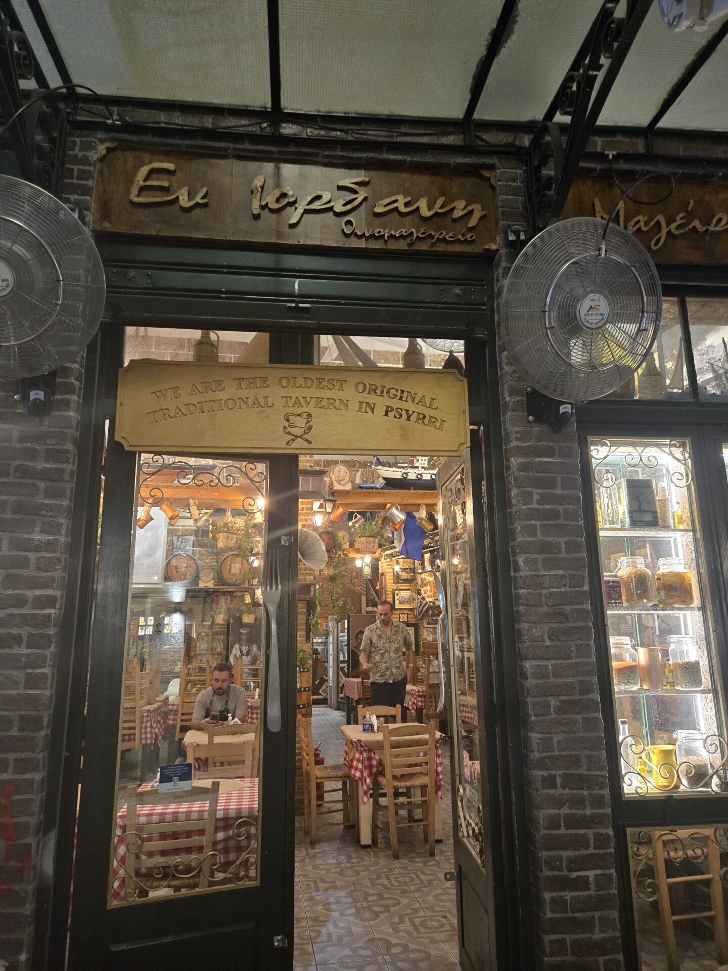 a storefront with a couple of people in front of it