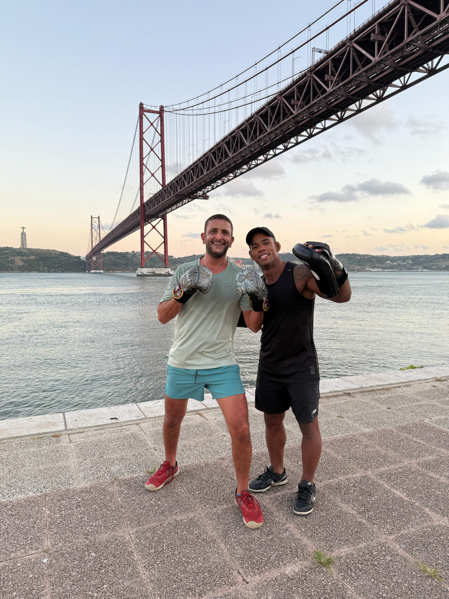 two men posing for a picture with boxing gloves
