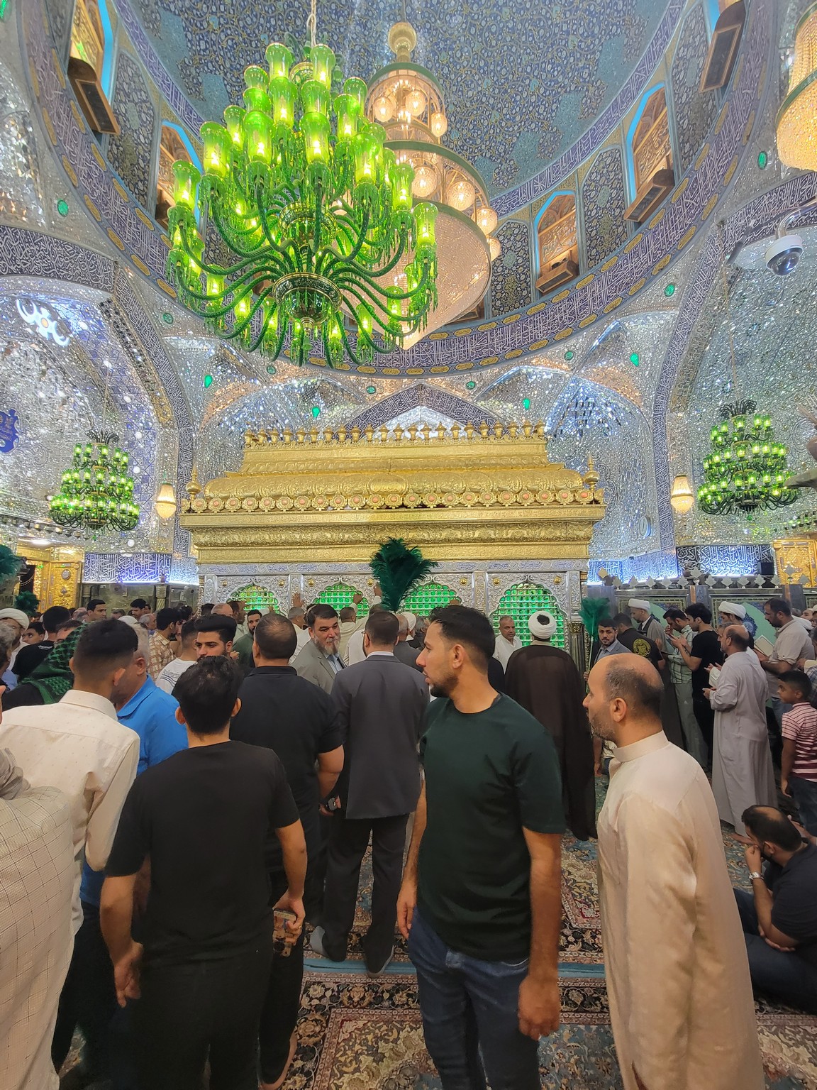 a group of people in a room with a large chandelier