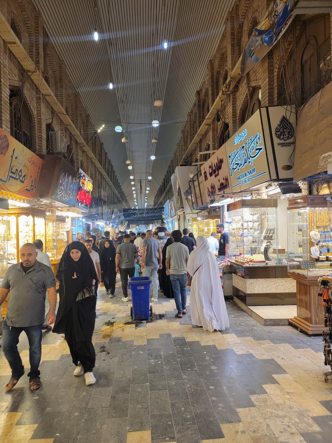a group of people walking in a market