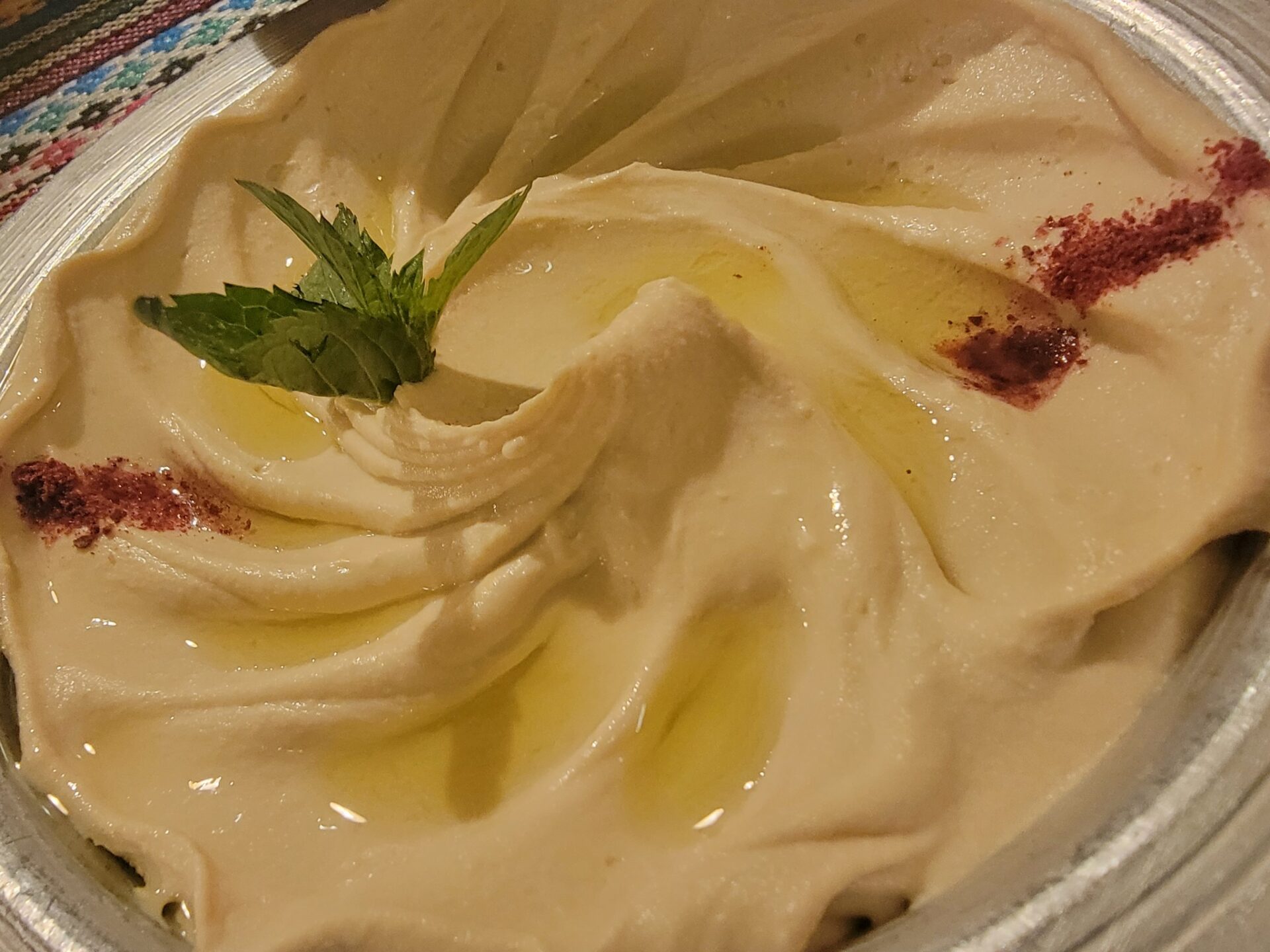 a bowl of food with a leafy green sprig