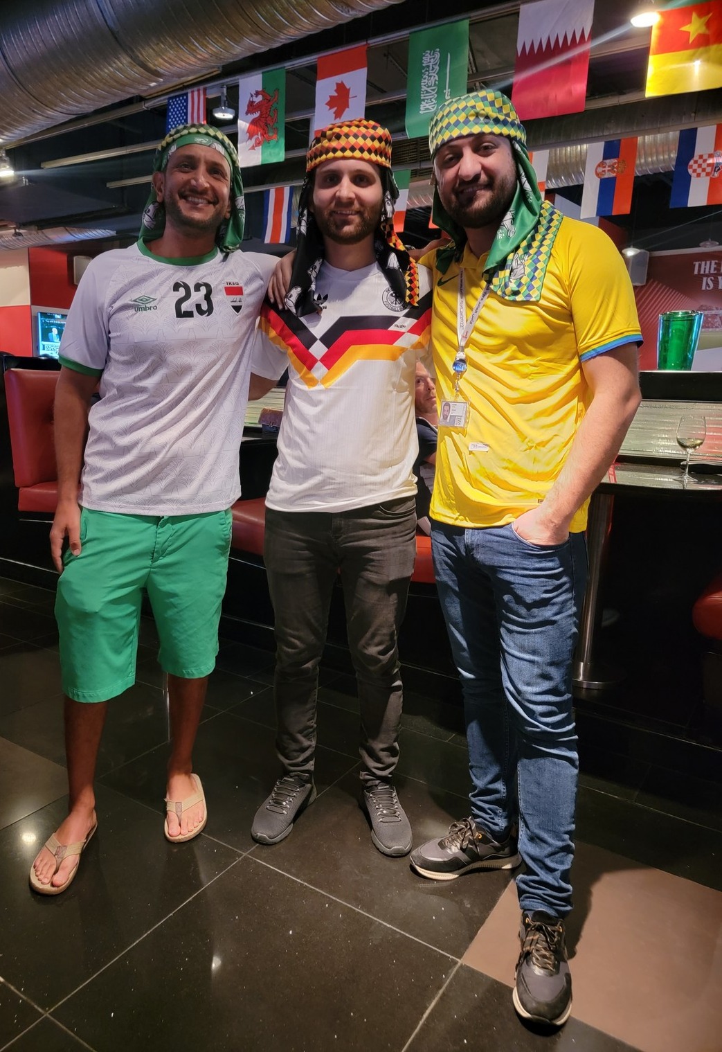 a group of men standing in a bar