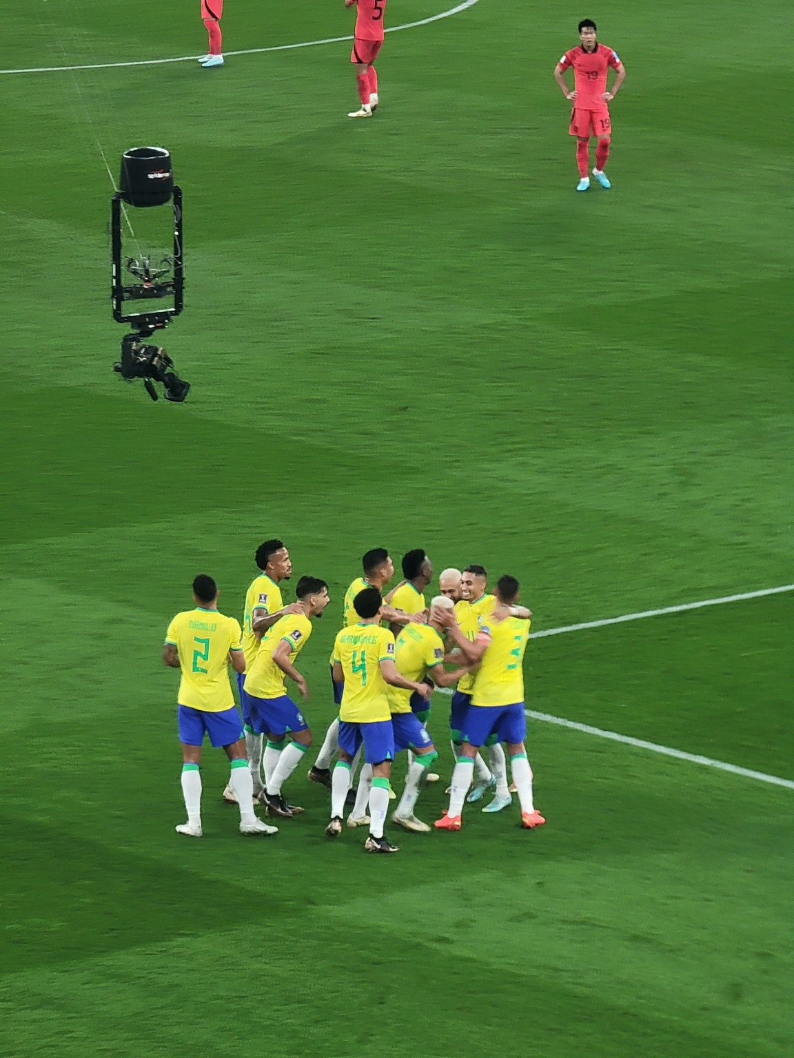 a group of football players huddling on a field