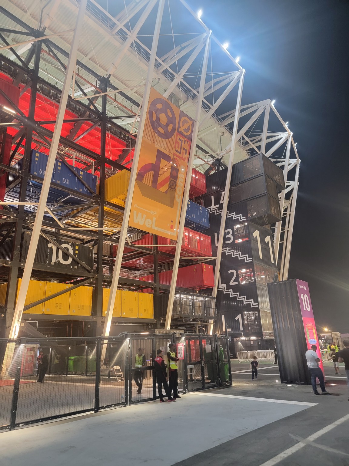 a large metal structure with many shipping containers