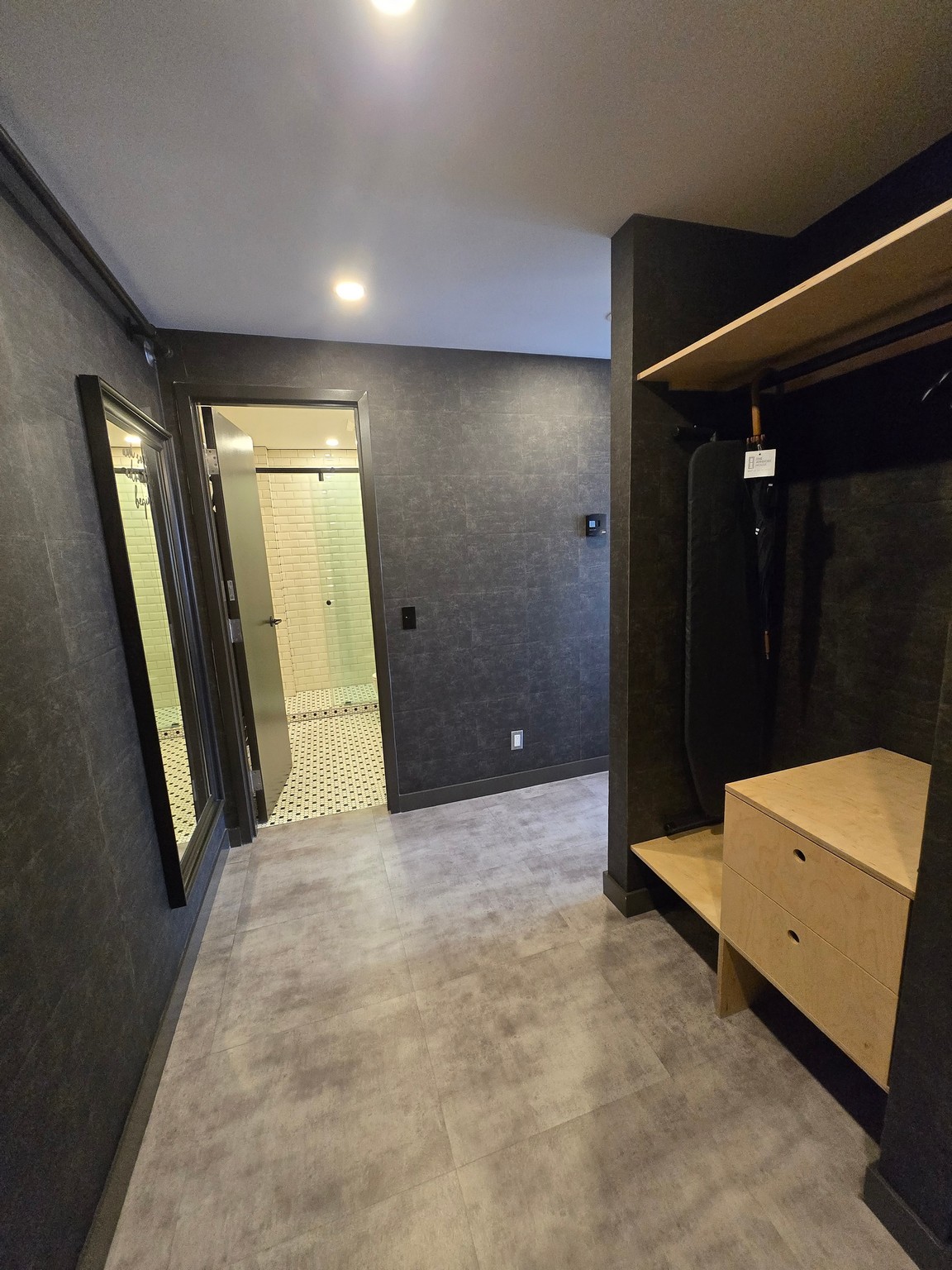 a hallway with a mirror and a closet