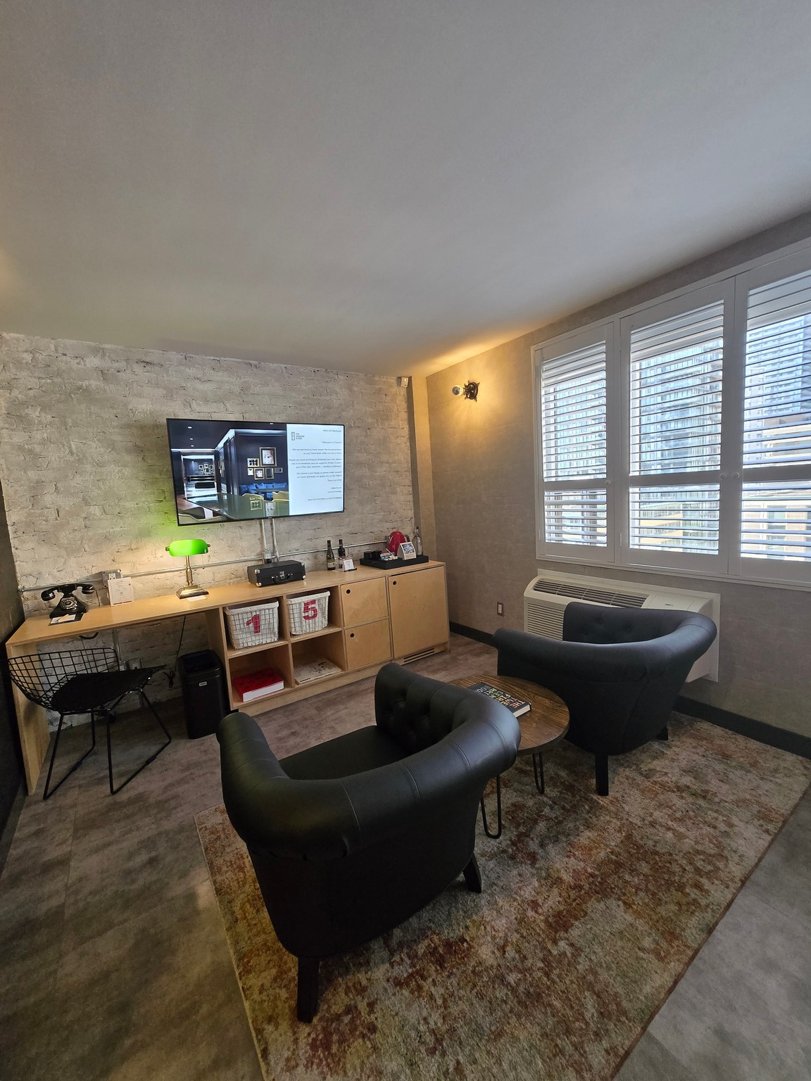 a room with a tv and chairs