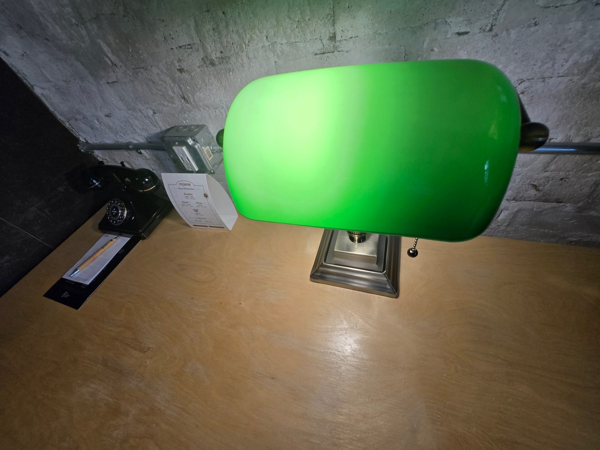 a green lamp on a desk