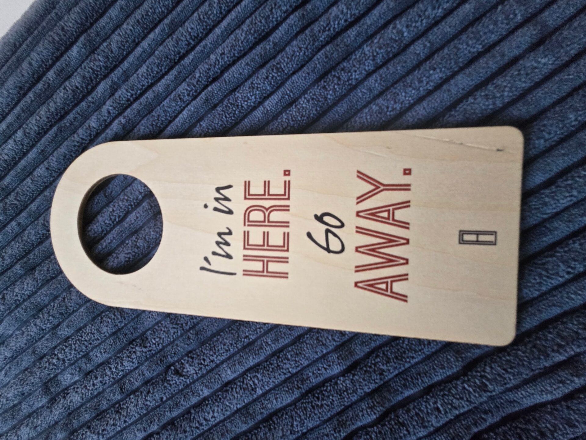 a wooden door swinger with a hole