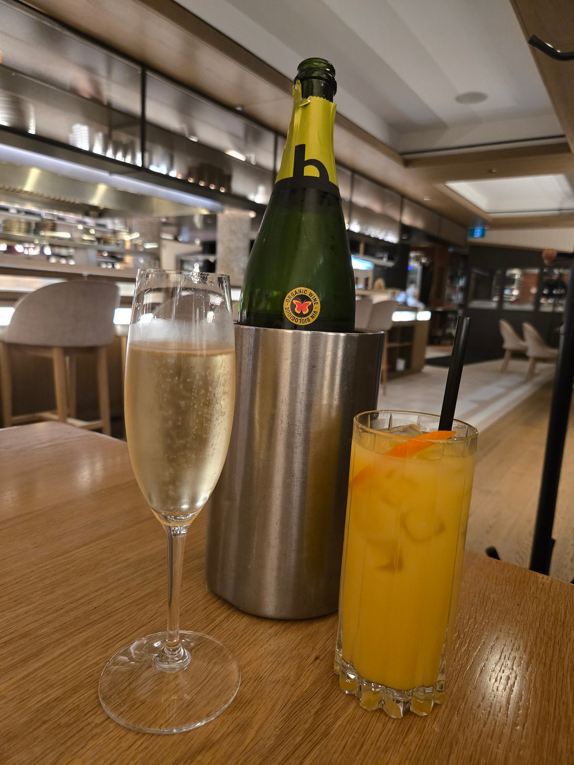 a glass of champagne next to a bottle of champagne