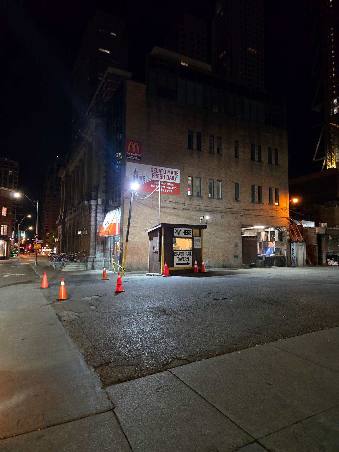 a street with a building and traffic cones