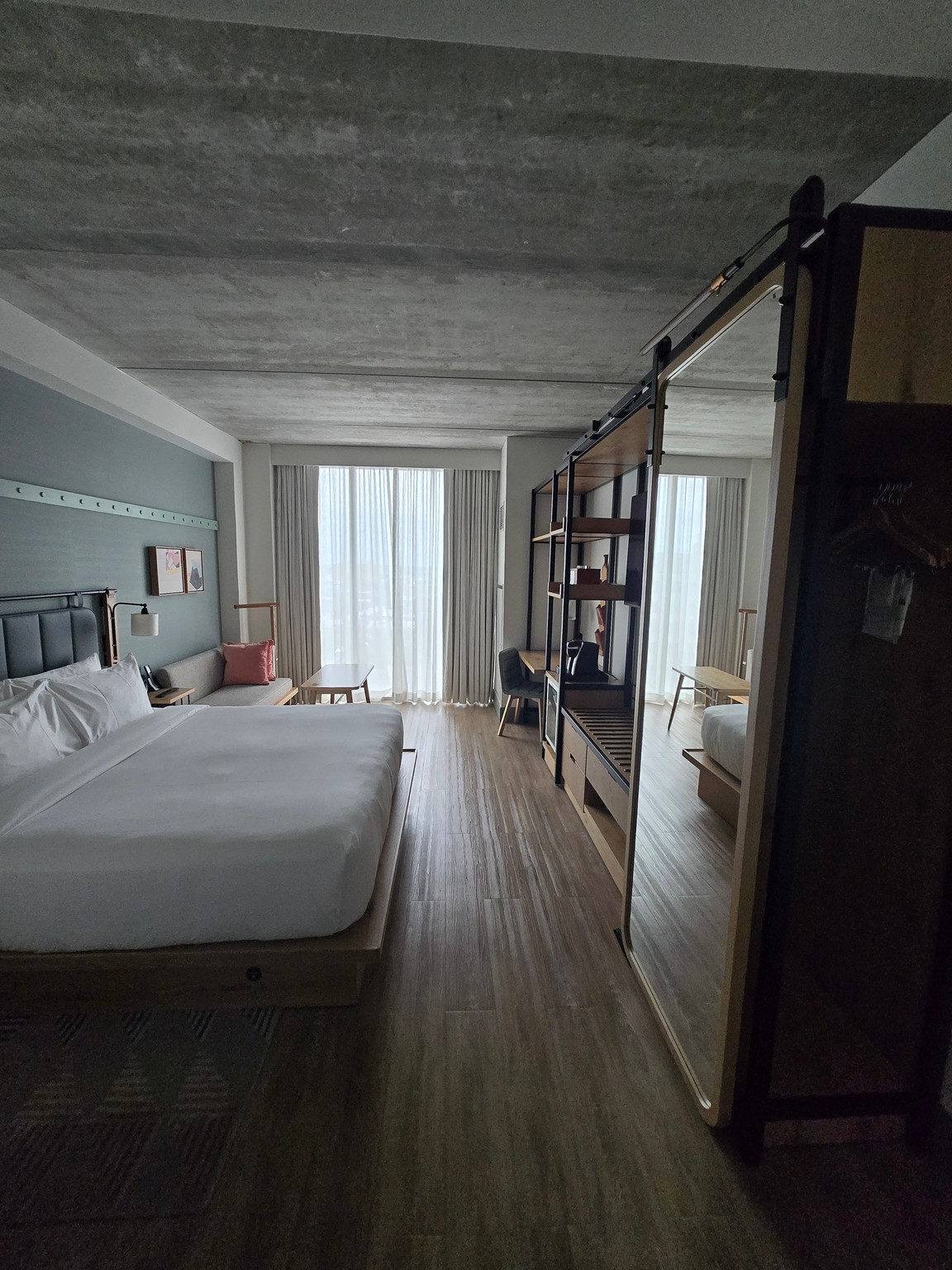 a room with a bed and a wood floor