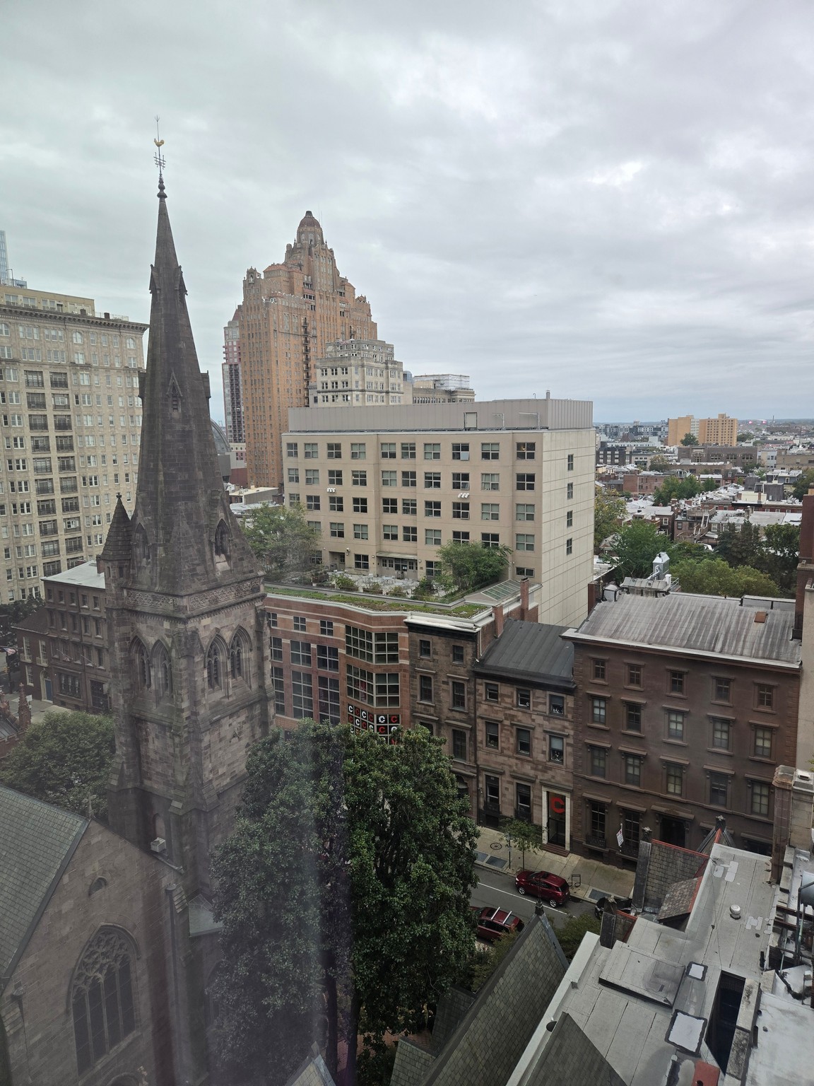 a city with tall buildings and a steeple