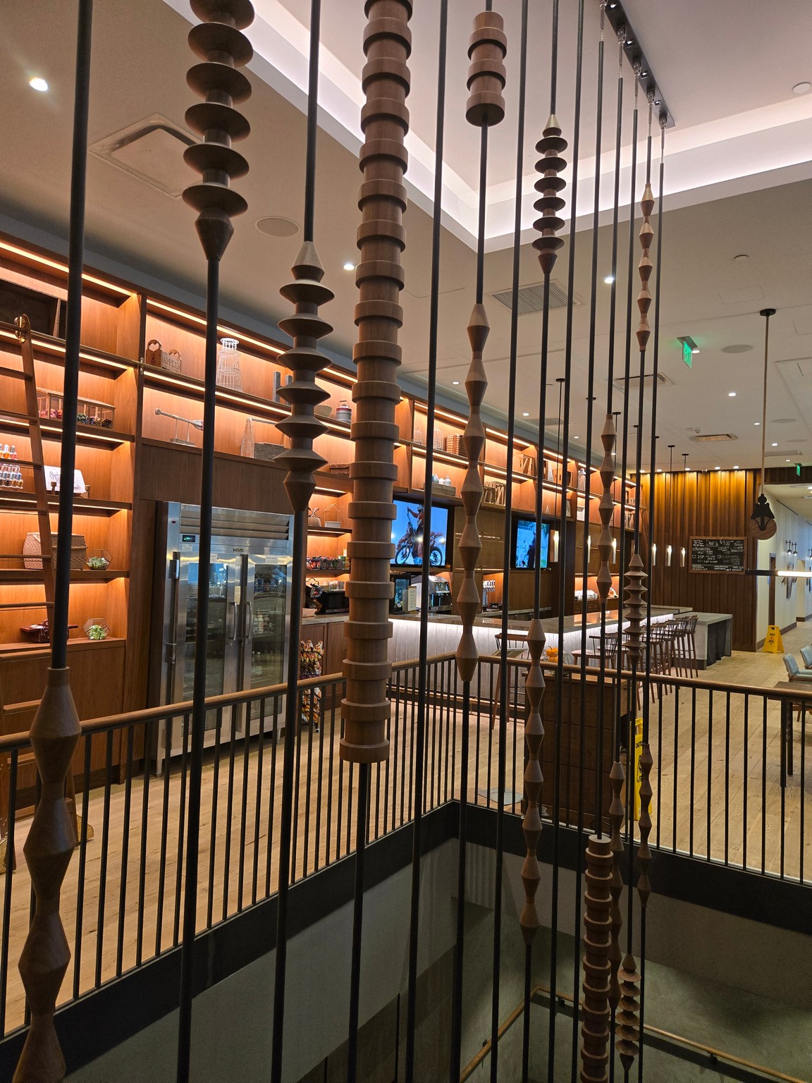 a room with wood columns and a bar