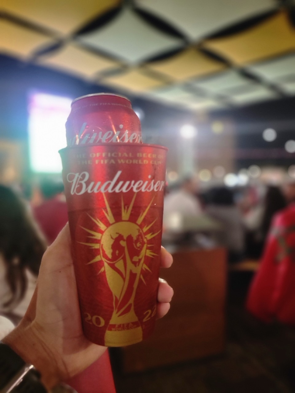 a person holding a red can