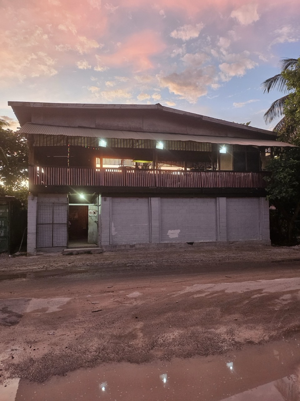 a building with a balcony and trees